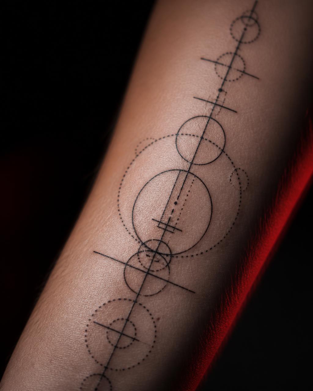 Macro shot of precision fine line geometric tattoo work