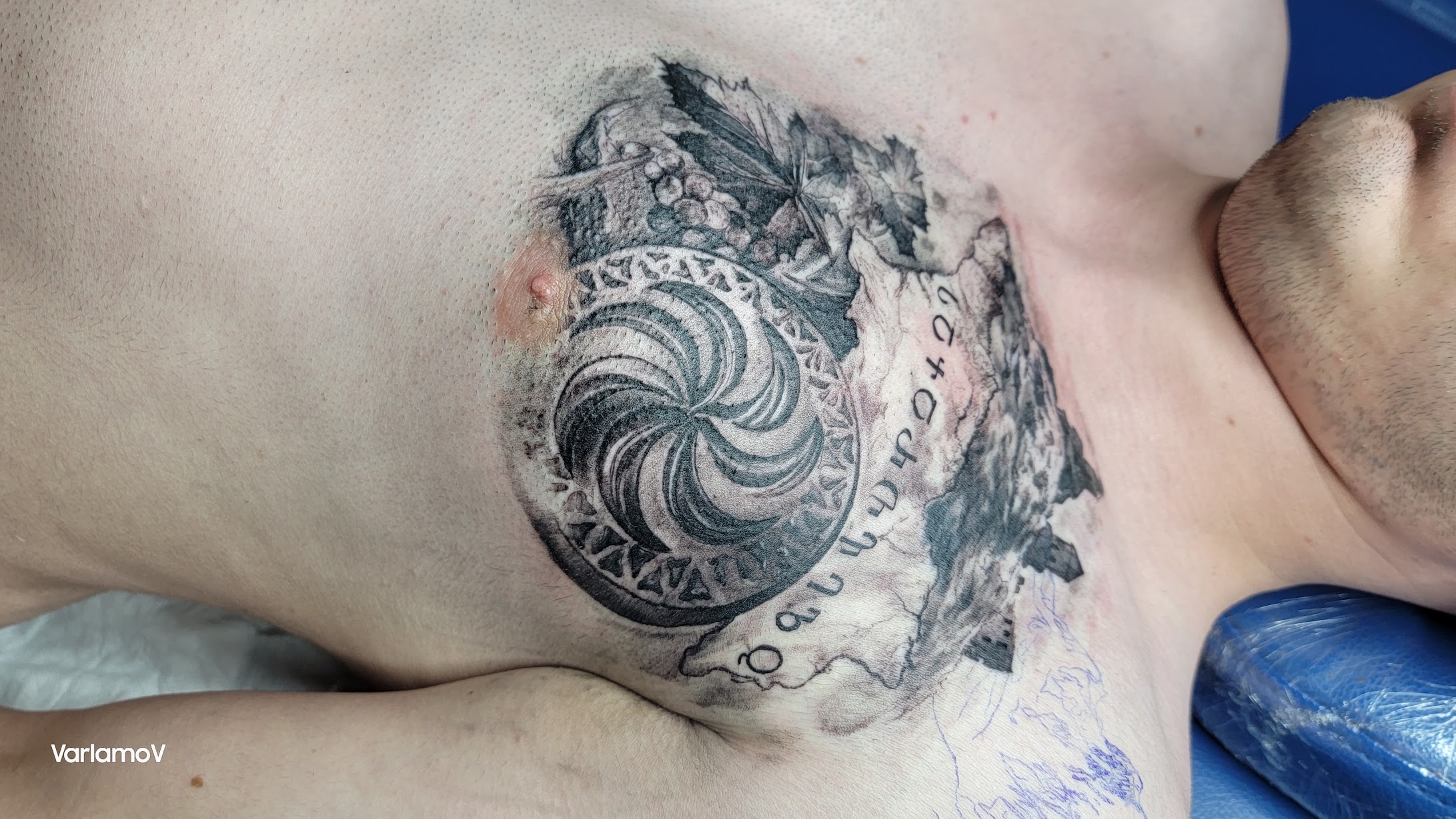 Fine line botanical stem tattoo on inner forearm